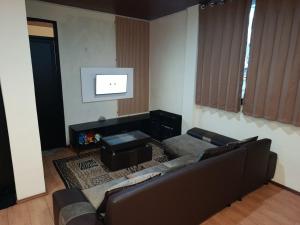 a living room with a couch and a table at Selaras Heritage Villa in Campaka
