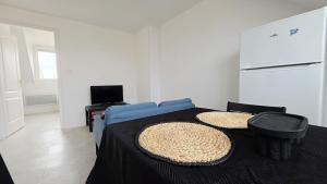 a bedroom with a blue bed with a black table at Studio Foch 4 in Grand-Fort-Philippe +2 photos