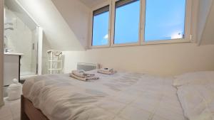 a bedroom with a large bed with two towels on it at Studio Foch 4 in Grand-Fort-Philippe
