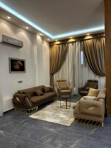 a living room with couches and chairs in a room at villa 578 in Sheikh Zayed