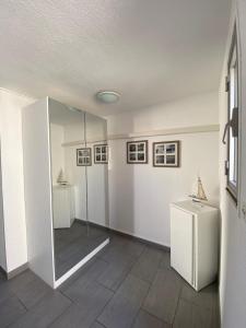 a room with a shower and a mirror in it at La casa du creux in Valras-Plage
