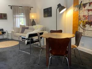 a living room with a table and chairs and a couch at Downtown, Contemporary and Artistic in Albany