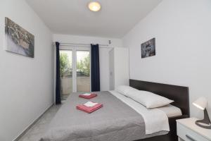 a bedroom with a bed with two red towels on it at Villa Feliks in Ljubač +139 photos