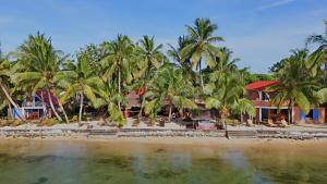a view of a beach with palm trees and houses at le Repaire des Pirates in Sainte Marie +125 photos
