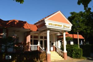 a house with a porch and stairs in front of it at Hotel und Restaurant Feustel in Plauen