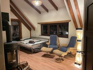 a living room with a bed and a fireplace at Ferienhaus Sprejnik Bautzen in Bautzen
