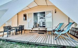 a house with a deck with chairs and a table at safari lodges in Moncarapacho