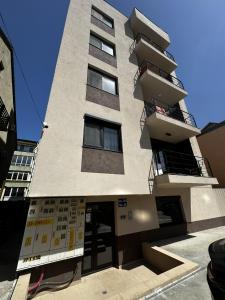 a tall building with balconies on top of it at La Playa Residence in Năvodari