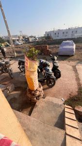 a group of motor scooters are parked in a lot at Madhuram Township in Jamnagar