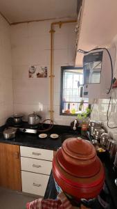 a kitchen with a stove and a counter top at Madhuram Township in Jamnagar