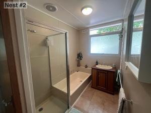 a bathroom with a shower and a tub and a sink at Grampians Nest in Halls Gap +41 photos