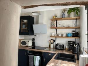 a kitchen with a sink and a counter top at The Dale - Luxurious annexe with stunning view in Buckden