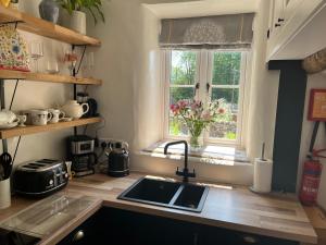 a kitchen with a sink and a window at The Dale - Luxurious annexe with stunning view in Buckden +28 photos