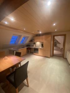 a kitchen with a wooden table and a dining room at Münsterblick in Wolframs-Eschenbach +16 photos
