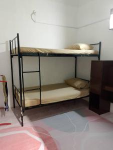 a black bunk bed in a room at Tipika Guest House - di Pasir Pekan sempadan 3 Daerah KB, Pasir Mas & Tumpat in Tumpat