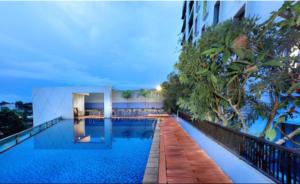 a swimming pool in the middle of a building at Aston Palembang Hotel & Conference Centre in Palembang