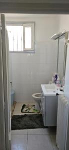 a bathroom with a sink and a toilet and a window at Villa Nanou Riviera in Nice