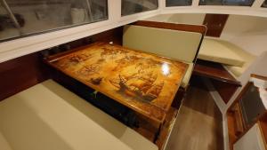 a wooden table with a painting of a ship on it at Over the Sea in Barcelona +8 photos