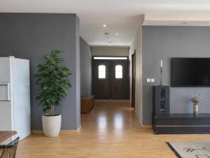 a hallway with a potted plant in front of a door at Filia Garden in Samos