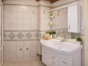 a white bathroom with a sink and a mirror at Filia Garden in Samos +12 photos