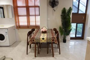 a table with a table cloth on it in a kitchen at Nadi Ease Stay Near McDonalds in Nadi +41 photos