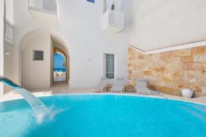 a swimming pool in a house with a dolphin in it at Palma Residence Salento in San Foca