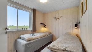 a bedroom with two beds and a window at Villavilla 546 - Hostrup Strand, Limfjorden in Spottrup