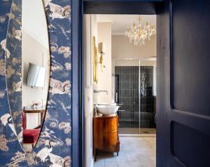 a bathroom with a sink and a mirror at Ziolì Apartment in Noto +14 photos