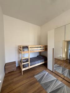a room with two bunk beds and a mirror at A Casa Lucia in Montefiascone
