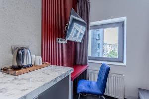a room with a table and a blue chair and a window at Abone Suites in Istanbul
