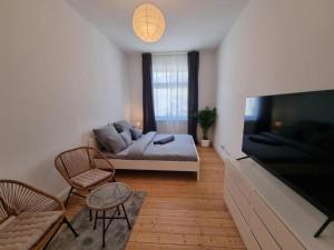 a living room with a bed and a large flat screen tv at Süße Marie 8 in Karlsruhe