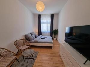 a living room with a bed and a flat screen tv at Süße Marie 8 in Karlsruhe +47 photos