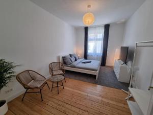 a living room with a couch and two chairs at Süße Marie 8 in Karlsruhe
