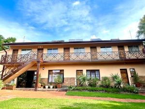 a building with a balcony on top of it at Clubview Guest House in Centurion
