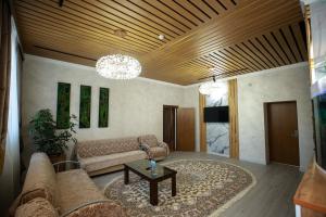 a living room with a couch and a coffee table at Asem Hotel in Nukus