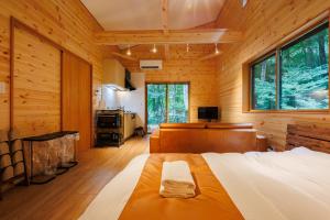 a bedroom with a bed and a desk in a room at Narusawa MADOKA in Narusawa