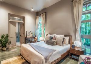 a bedroom with a large bed and a window at LohonoStays Castello Villa 2 in Assagao