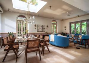 a living room with a table and a blue couch at LohonoStays Castello Villa 2 in Assagao