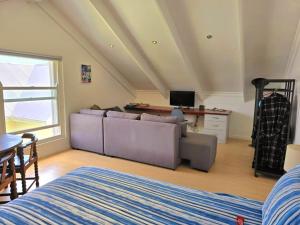 a living room with a couch and a table at Penguin's at Sea in Grotto Bay