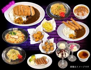 a table topped with plates of food with different foods at ホテルツクバランド in Tōgane