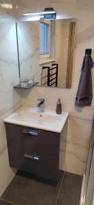 a bathroom with a sink and a mirror at MaxLux Apartments in Slovenj Gradec +24 photos