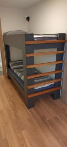 a bunk bed in a room with a wooden floor at MaxLux Apartments in Slovenj Gradec