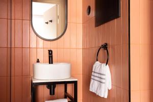 a bathroom with a sink and a mirror at La Dépendance in Paris +20 photos