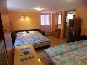 a bedroom with two beds and a book in a room at Szonja Apartman in Egerszalók