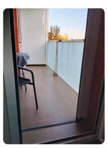 a view through a glass door of a balcony with a chair at Apartamento en Huesca capital in Huesca +4 photos
