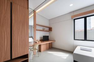 a room with a desk with a computer and a window at Cove Alexa in Jakarta