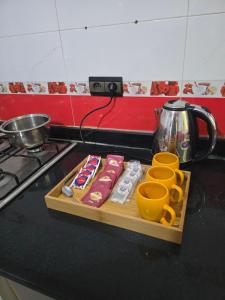 a cutting board with food and cups on a kitchen counter at Hostel Dar Khelifa in Tétouan