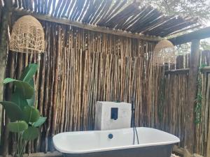 a bathroom with a bath tub and a wooden wall at Edjami River View in Marloth Park +25 photos