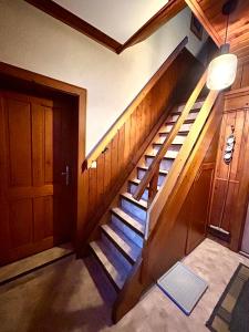 a wooden staircase in a house with a door at Ferienhaus Feichtn Schuster in Gosau