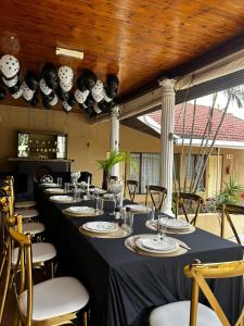 a long table with chairs in a room at Ulifalodge & functions in Durban